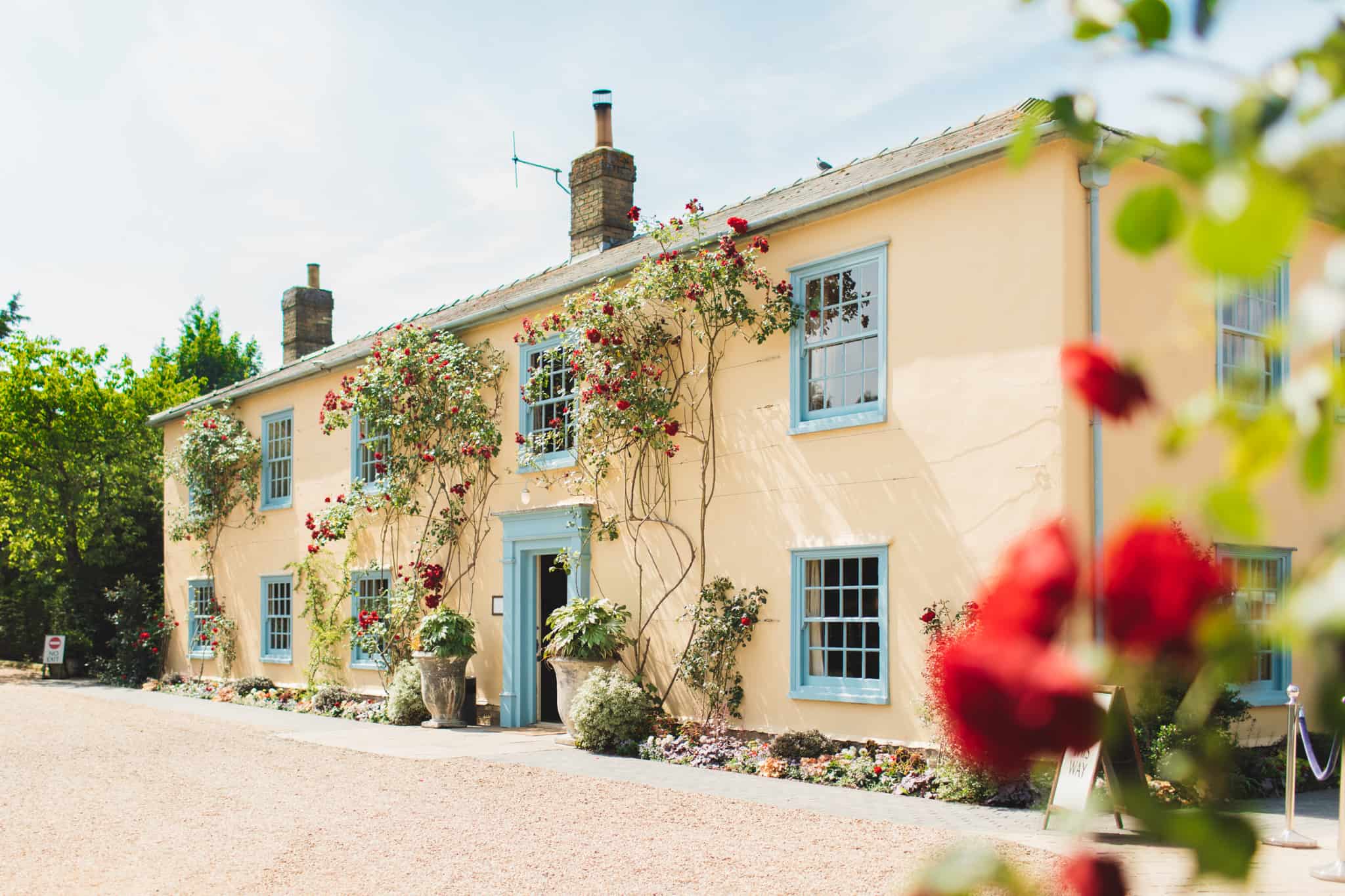 South Farm Countryside Wedding Venue Red Roses around door