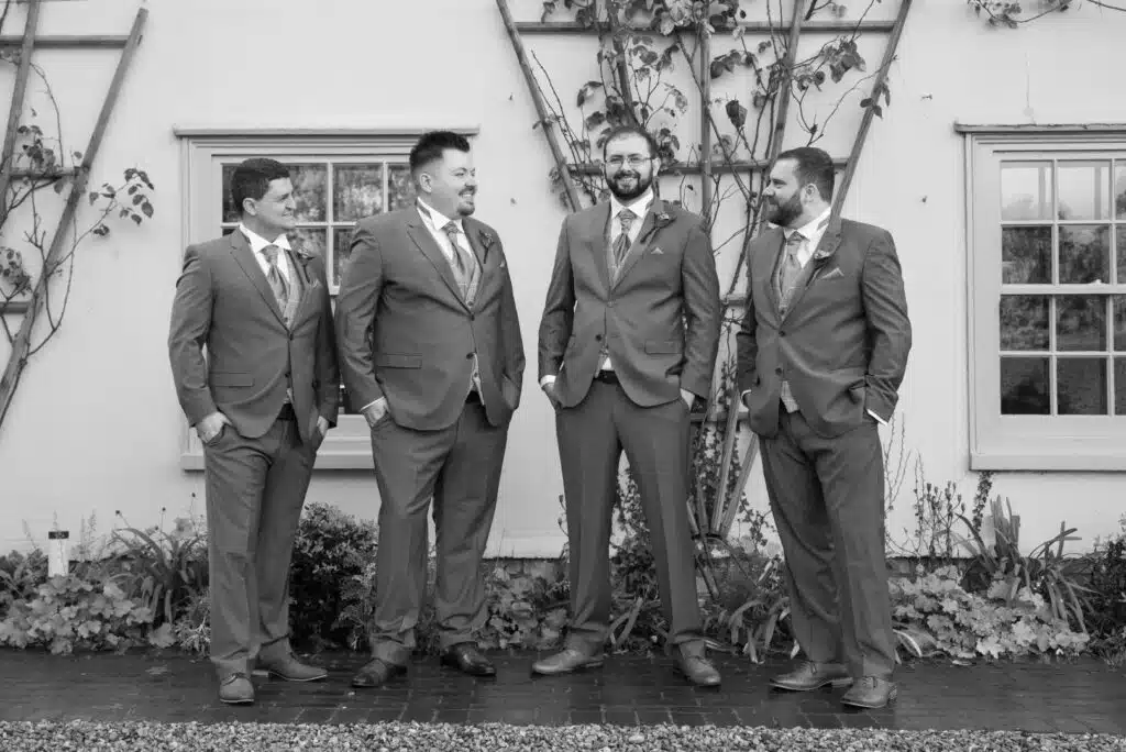 Groom and his Groomsmen having a photo at the front of country Farmhouse 