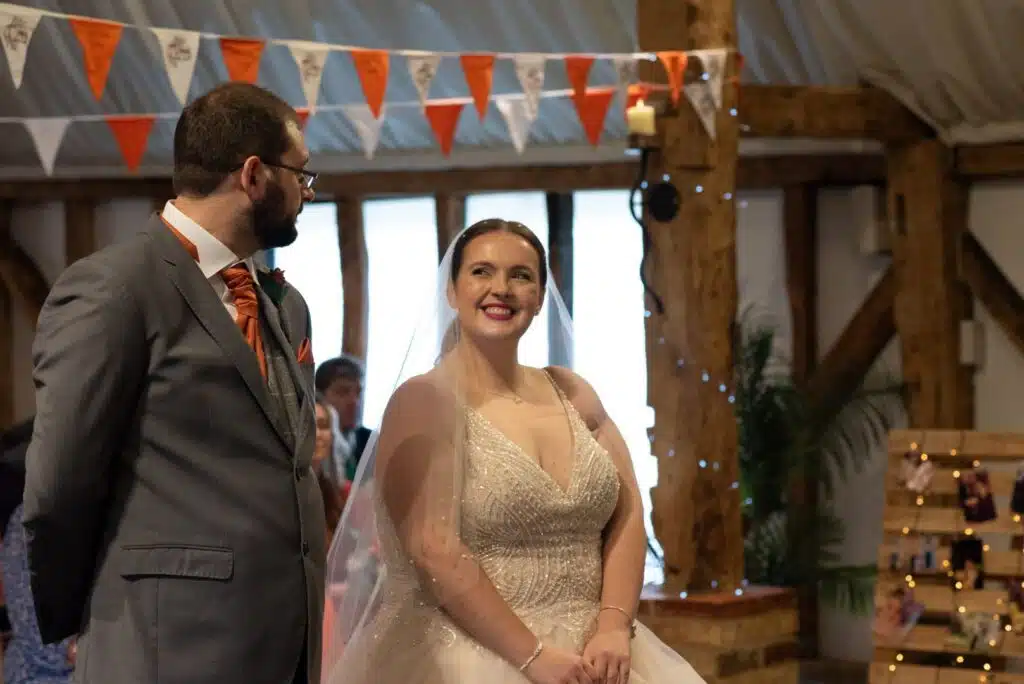 Bride and Groom taking a special moment at countryside barn wedding venue during ceremony in the Tudor Barn.