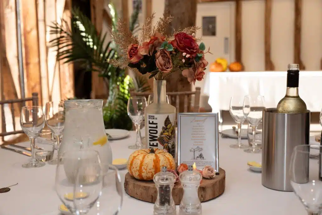 Warm Autumnal table decor in the rustic Tudor Barn at Hertfordshire countryside wedding venue