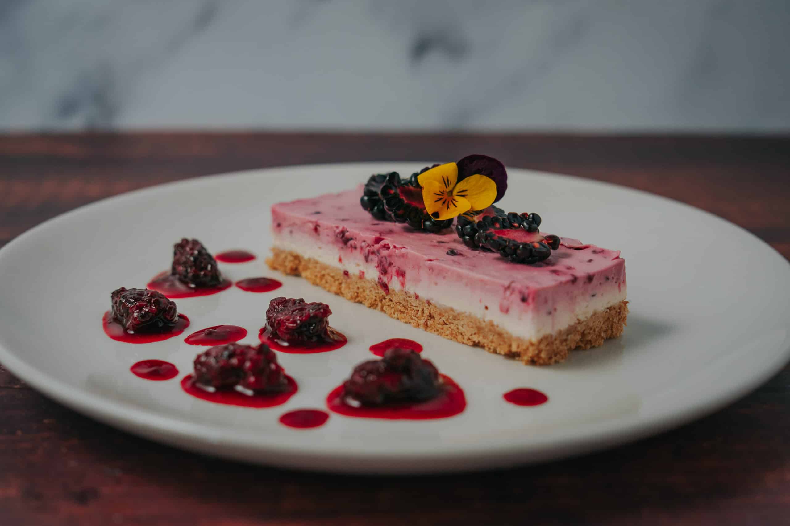 Mixed berry cheesecake dessert with berries plated wedding food at award winning wedding venue
