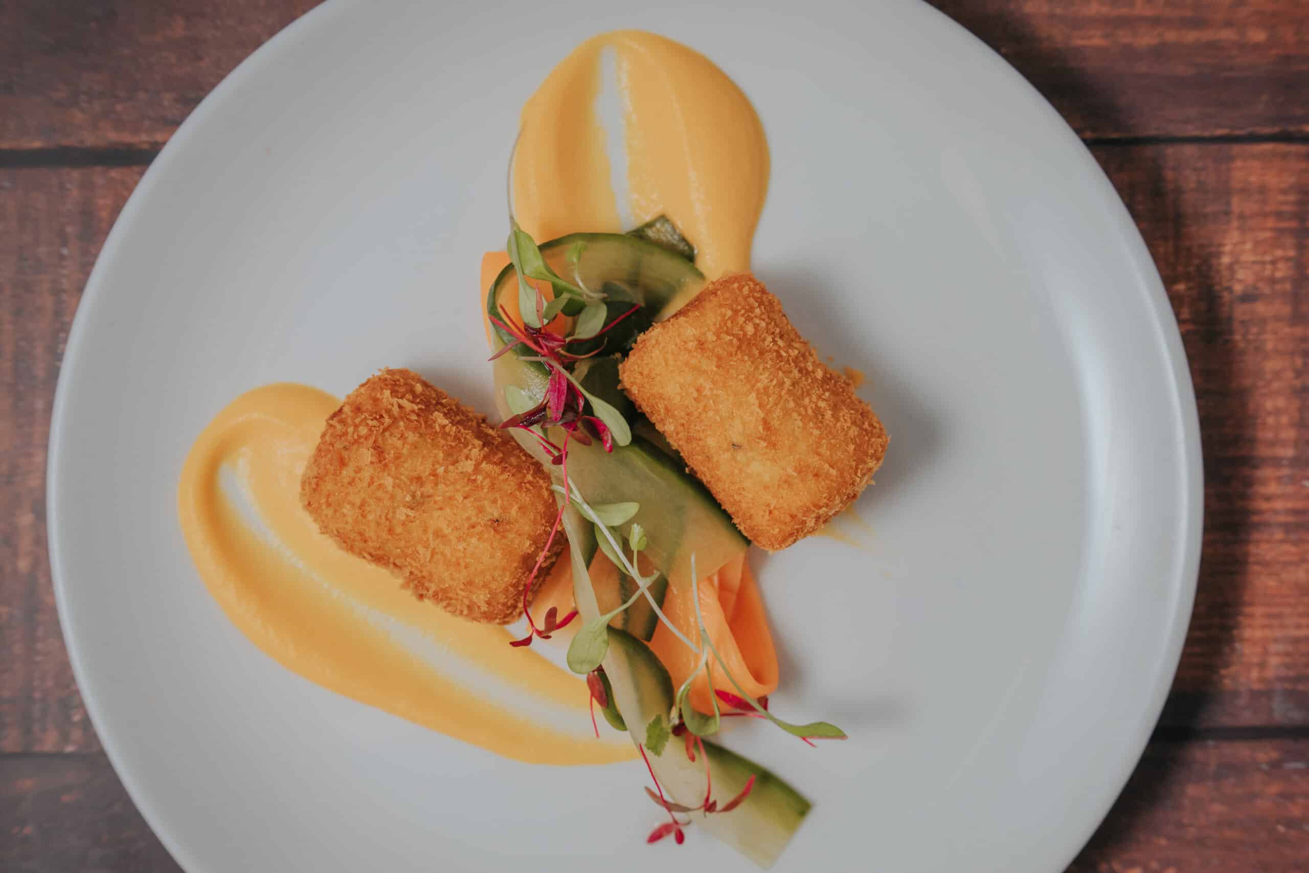 Plant based croquette starter planted with home grown vegetables and a pretty jus