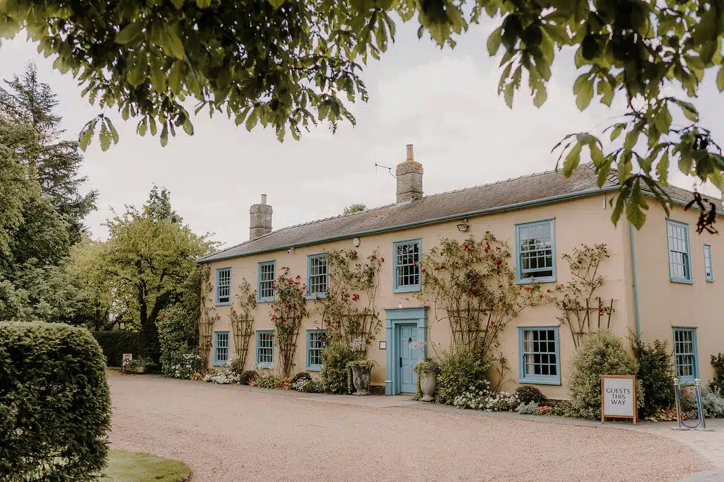 Charming country farmhouse adorned with red dublin bay roses