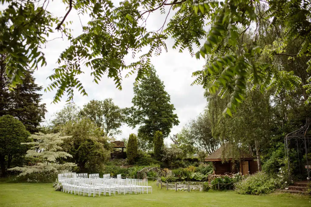 Outdoor ceremony in the Summer House surrounded by beautiful landscaped gardens