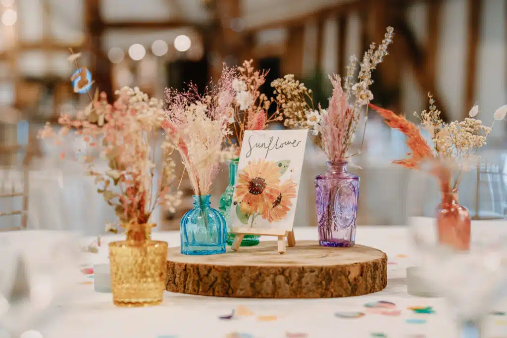 Dried colourful flowers in vases decorated on tables in the Tudor Barn