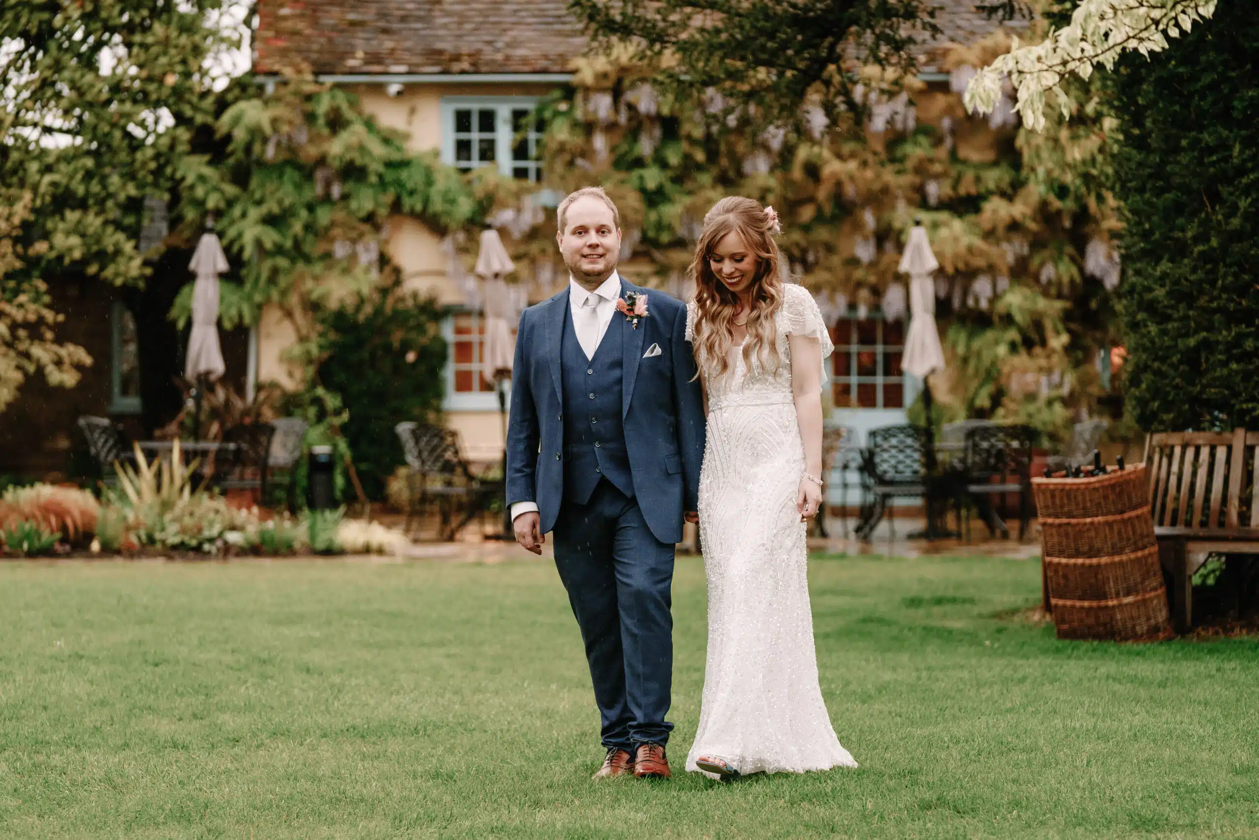 Bride and Groom walking in the Gardens at outdoor countryside wedding venue based in Hertfordshire and Cambridhshire