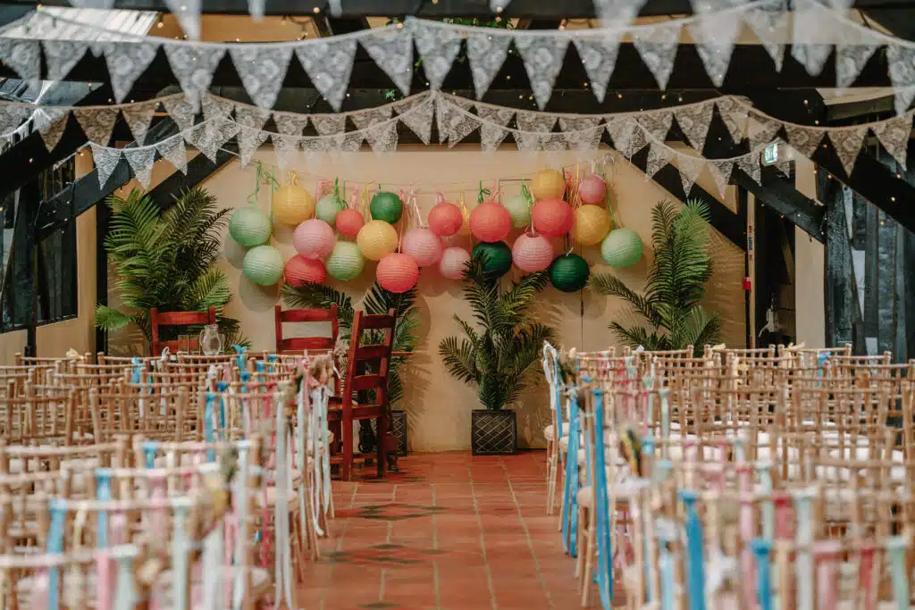 The Old Dairy set beautifully for a ceremony. Decorated with colourful balloons and bunting