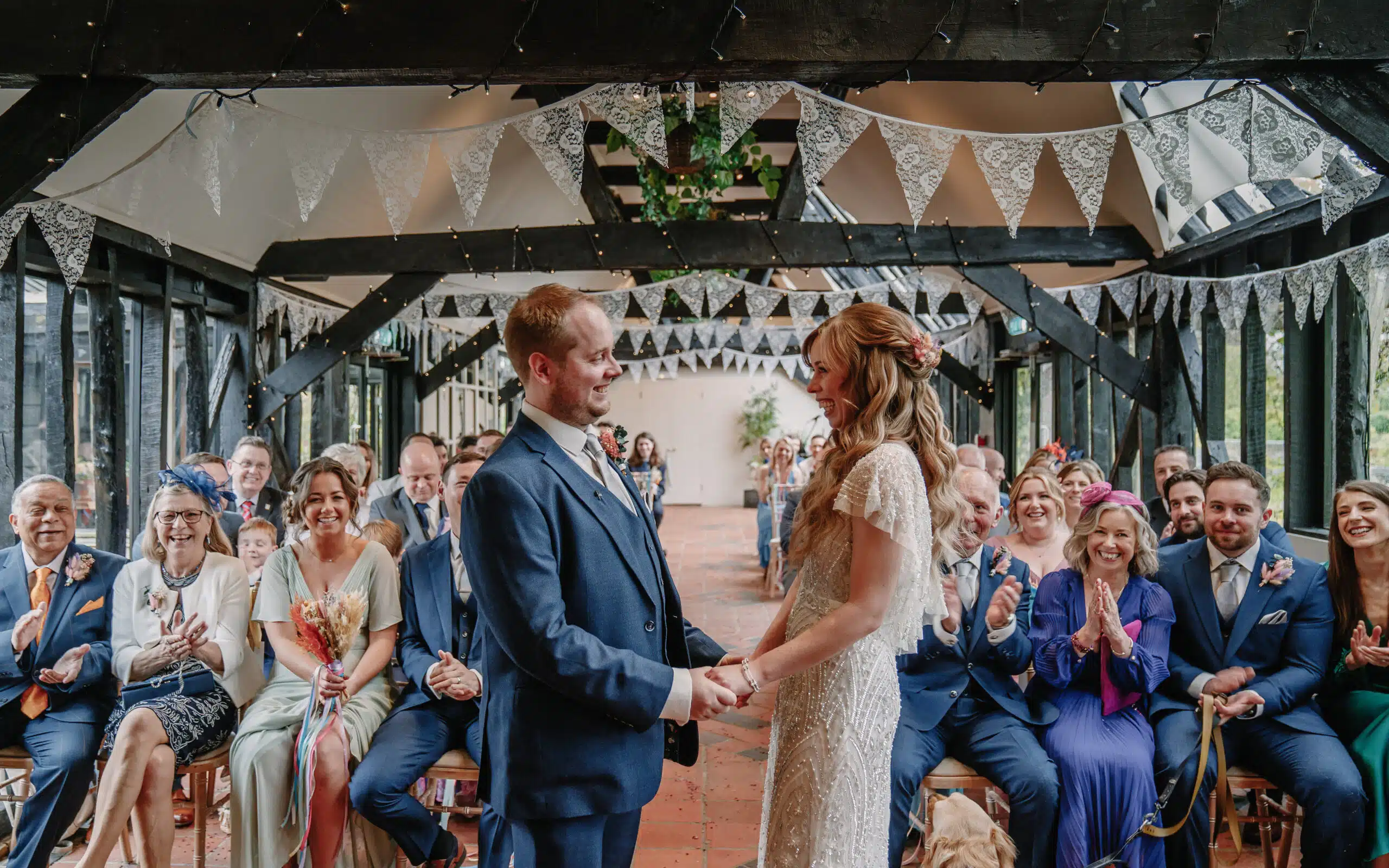 Bride and Groom during their ceremony in the Old Dairy sharing a special moment.