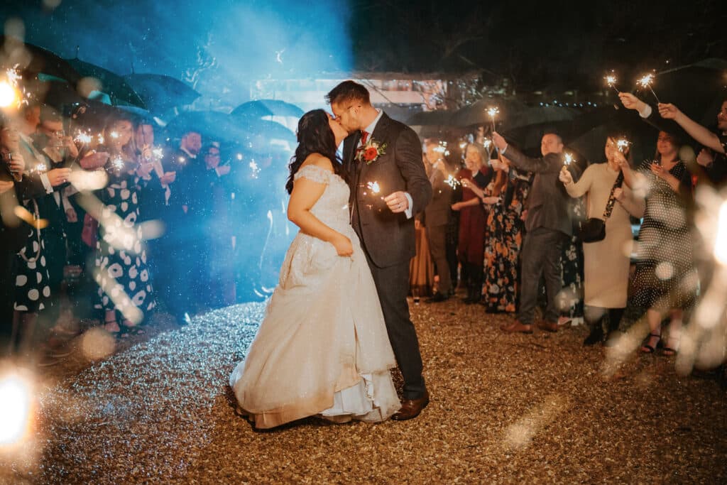 Bride and Groom have sparkler shot in South Farm's courtyard amongst their friends