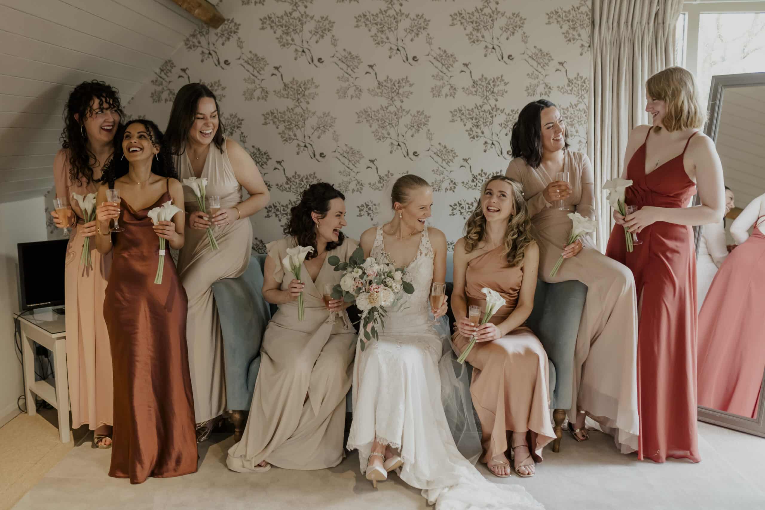 Bride and her Bridesmaids in the Coach House Suite sipping on a glass of celebratory bubbly moments before walking down the aisle