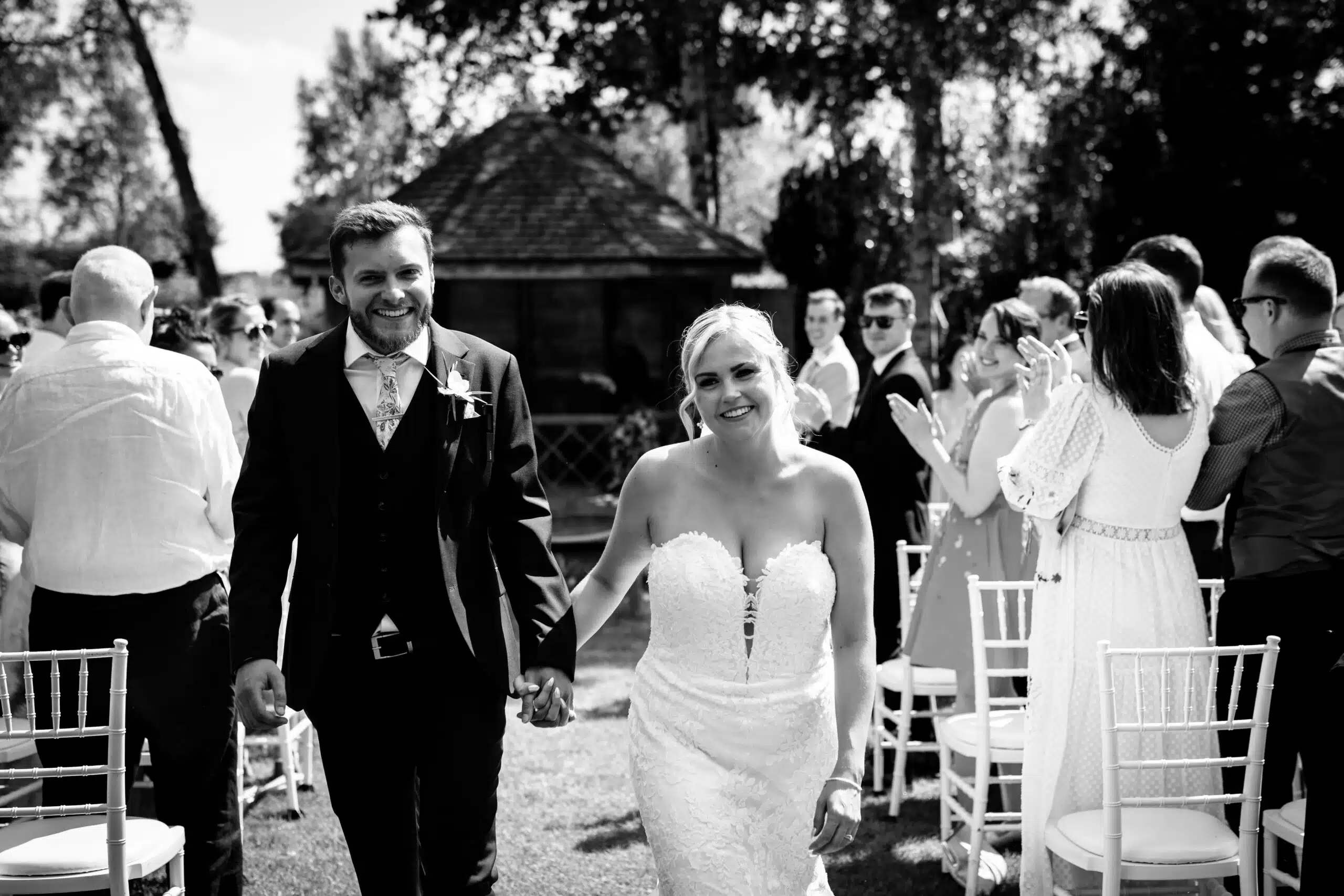 Bride and Groom walking up the aisle after their ' I dos' in the Summer House
