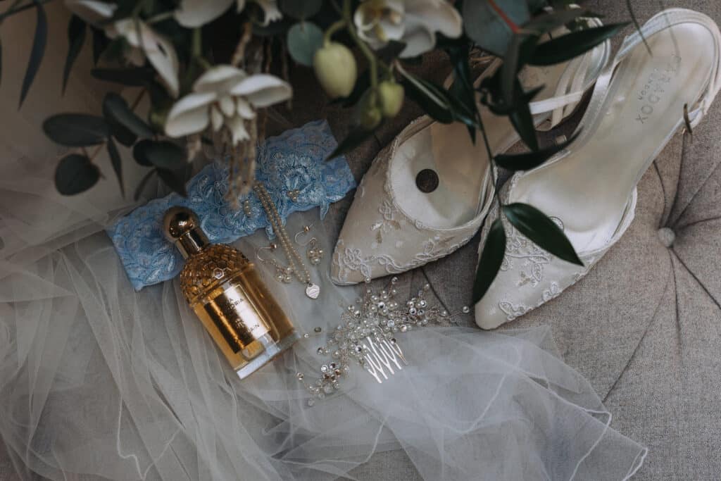 Brides heels and perfume in the Coach House Suite