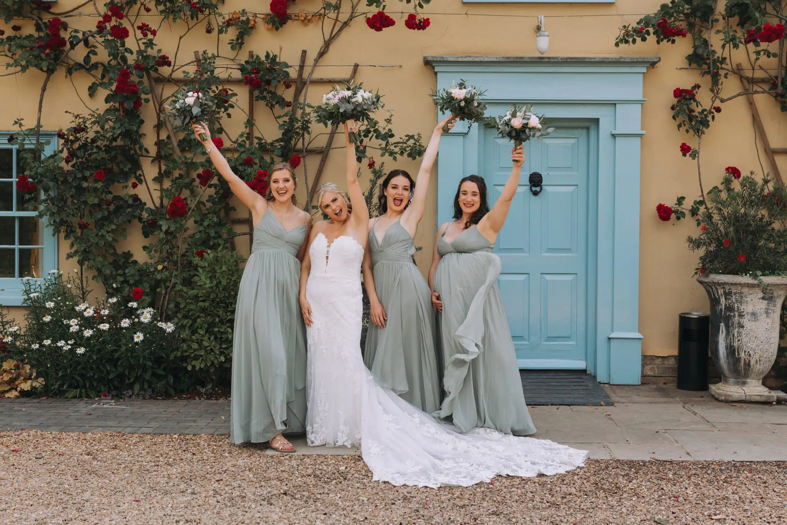 Bride and her Bridesmaids hands air with boquets at sustainable wedding venue in Cambridgshire