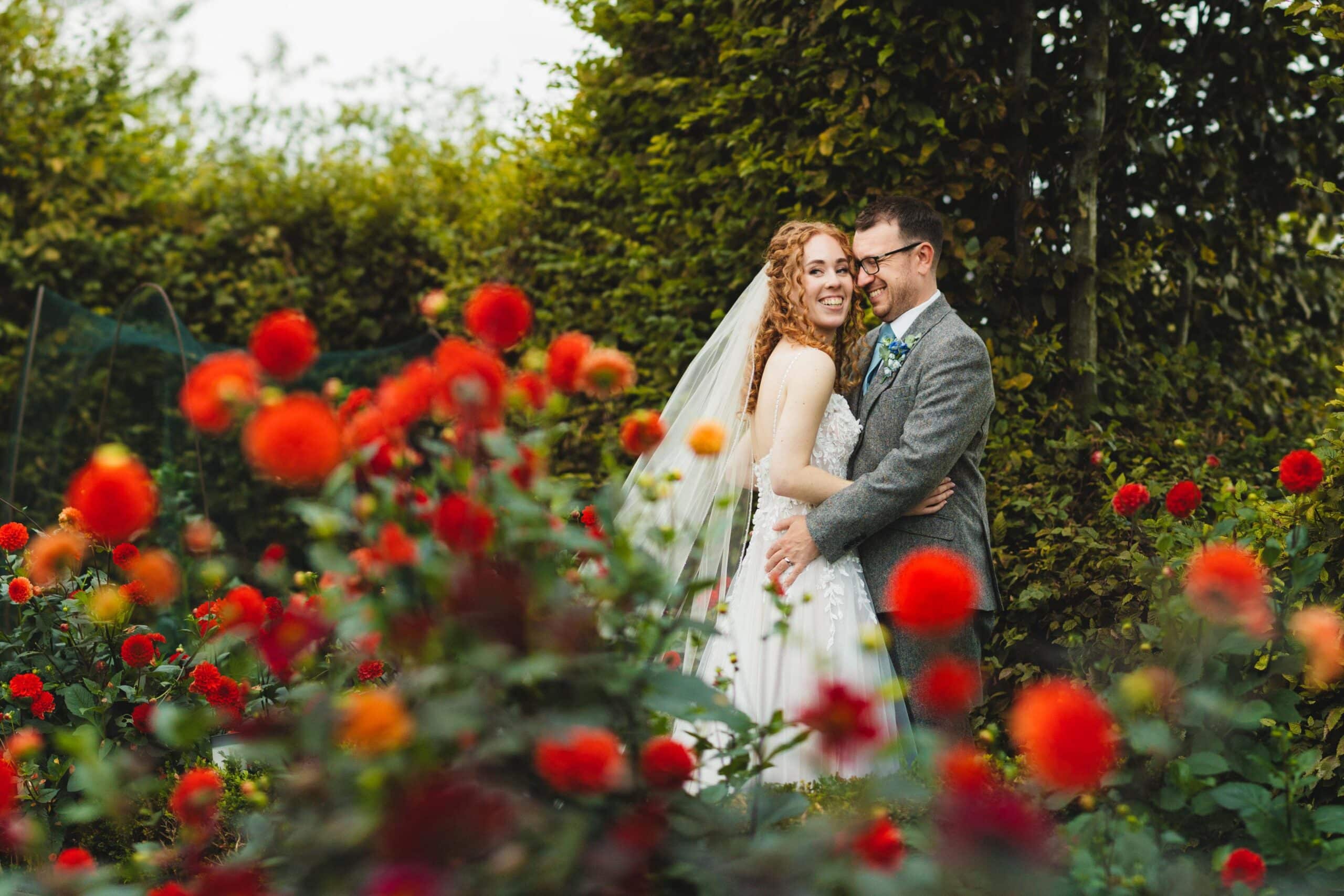 Bride and Groom in amongst the Dahlia's in the Kitchen Garden 