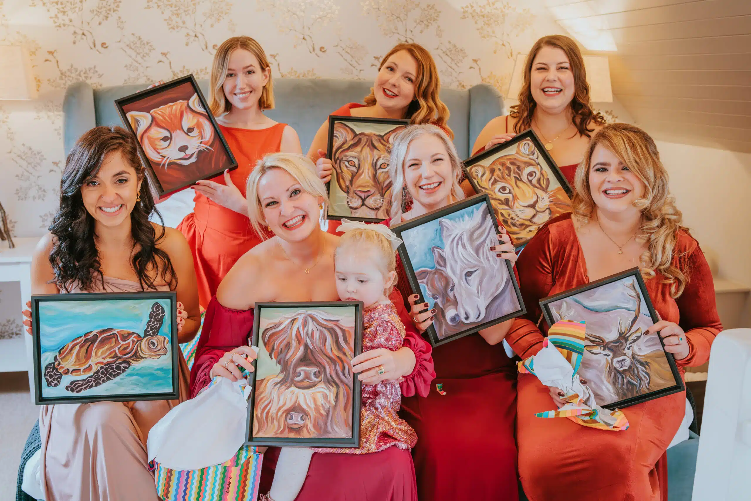 Bride with her bridal party in the Coach House Suite showcasing portraits hand painted for them
