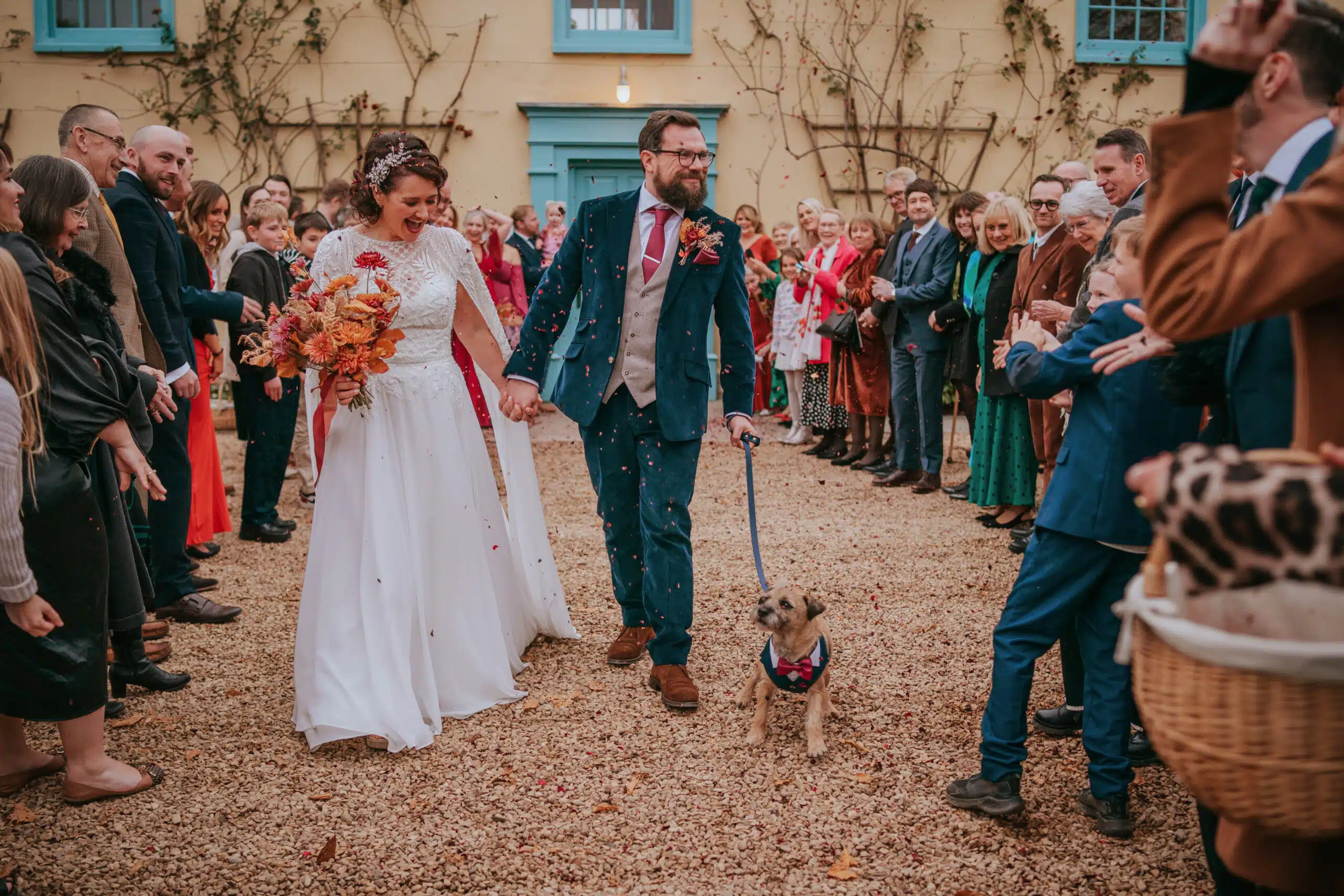 Bride and Groom having confetti photo at the front of the Farmhouse at South Farm based in Hertfordshire