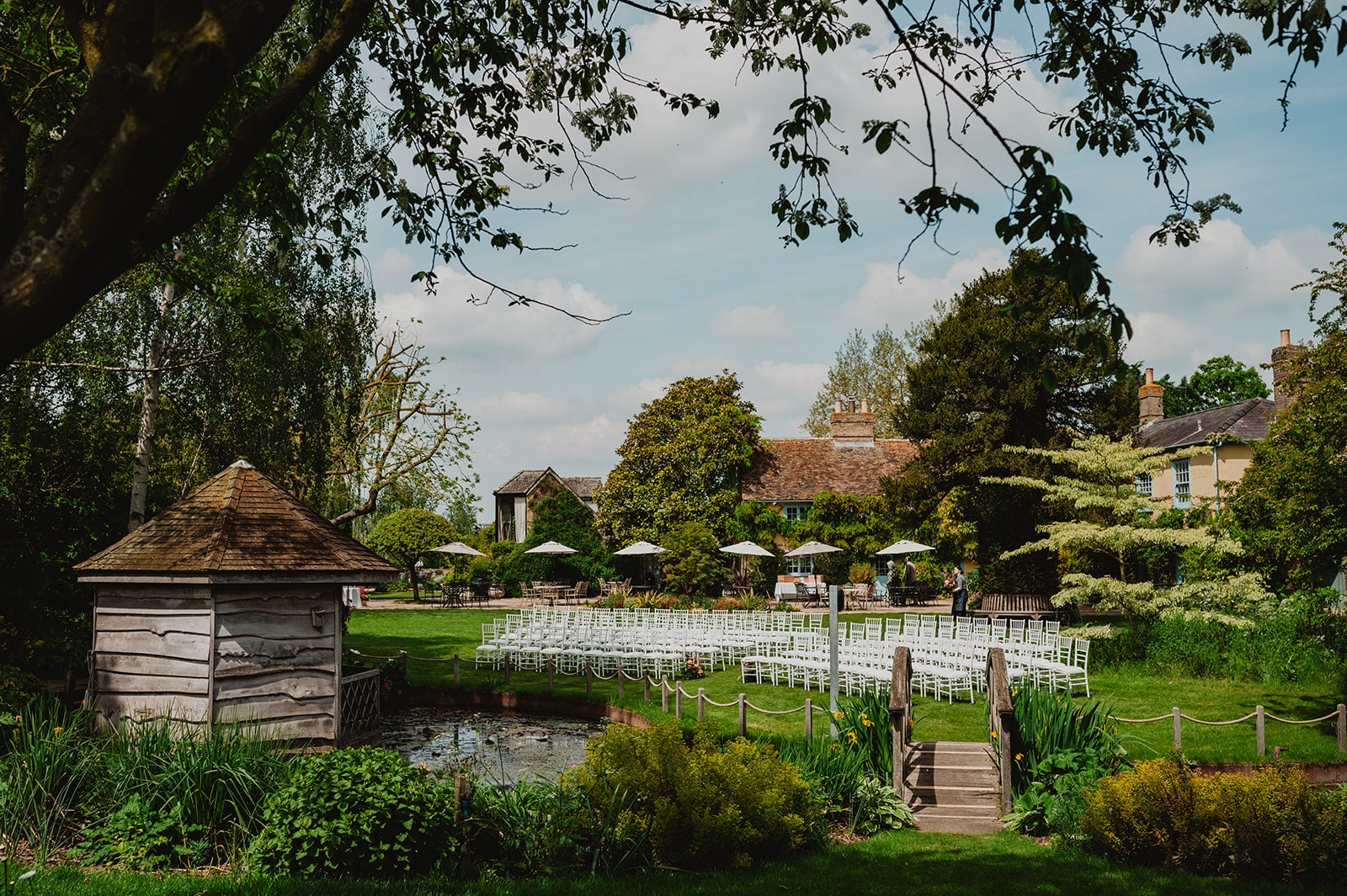 The Summer House all set out with white chairs on the lawn at outdoor garden wedding venue