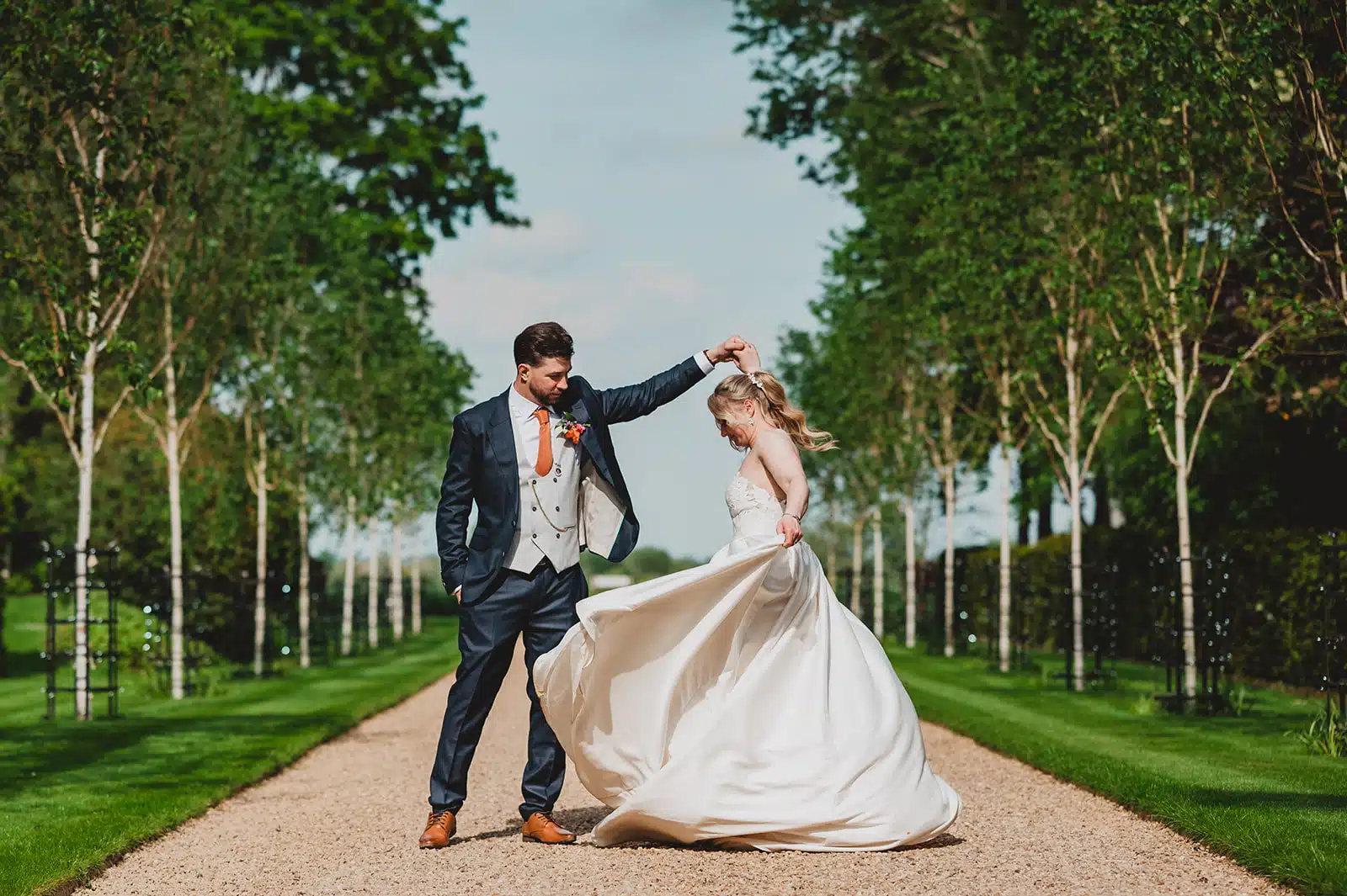 Bride and Groom on the fairy-lit driveway at South Farm based in Cambridgshire