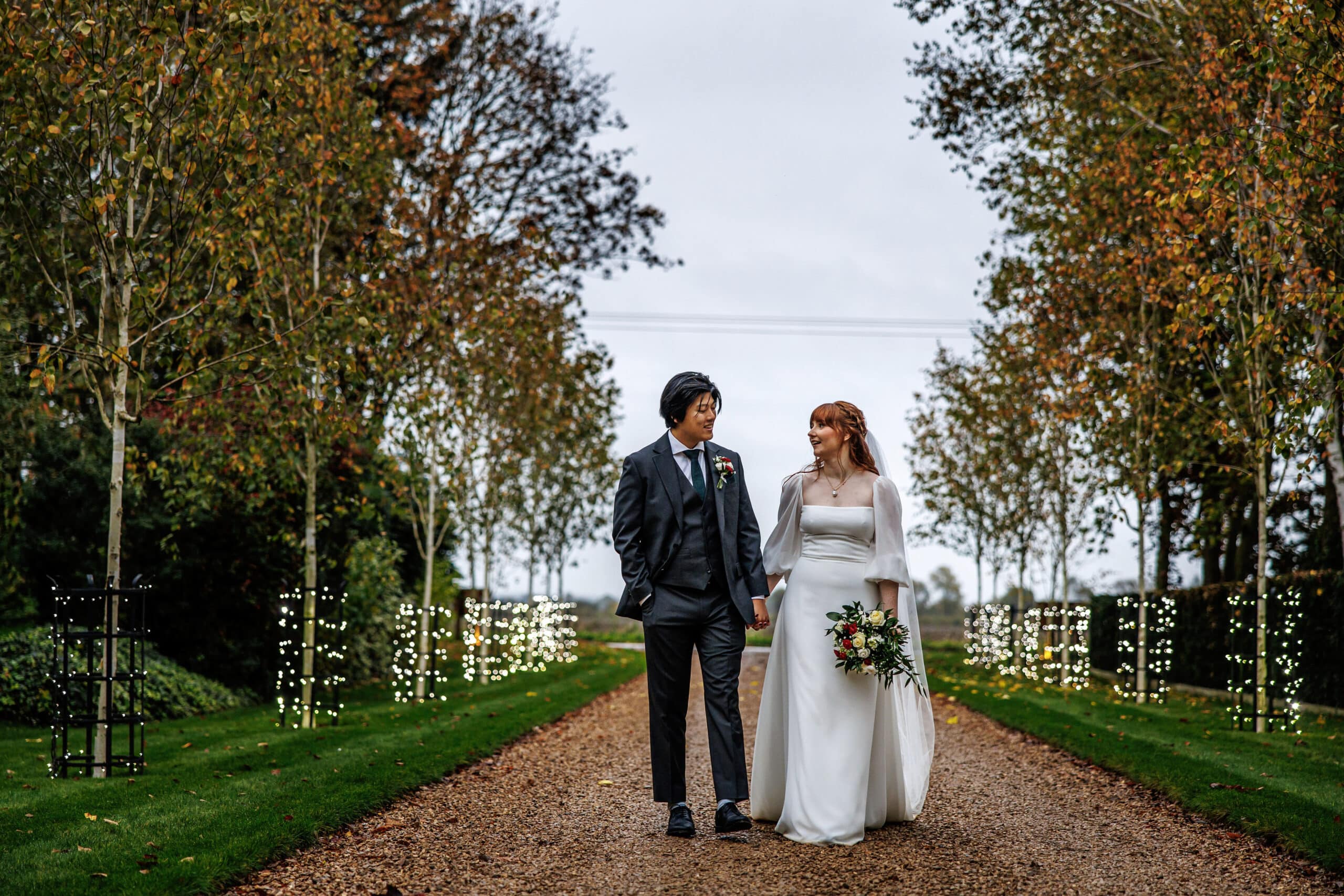 Bride and groom on driveway at countryside wedding venue autumn