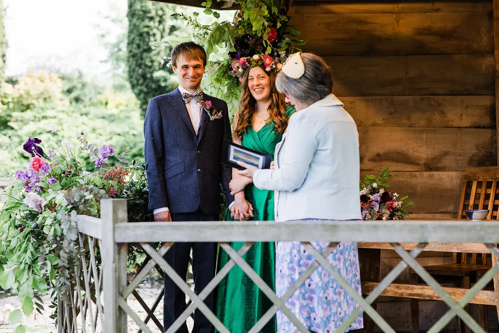 Bride and Groom standing in the Summerhouse at outdoor garden wedding venue having a humanist ceremony