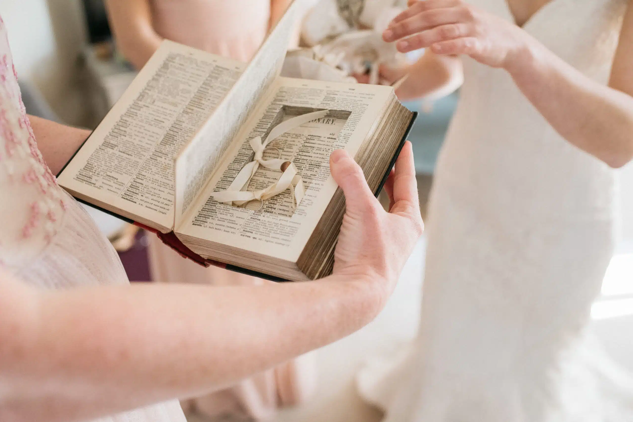 Bride and Bride receiving rings during intimate ceremony in the charming Old Dairy at barn style wedding venue