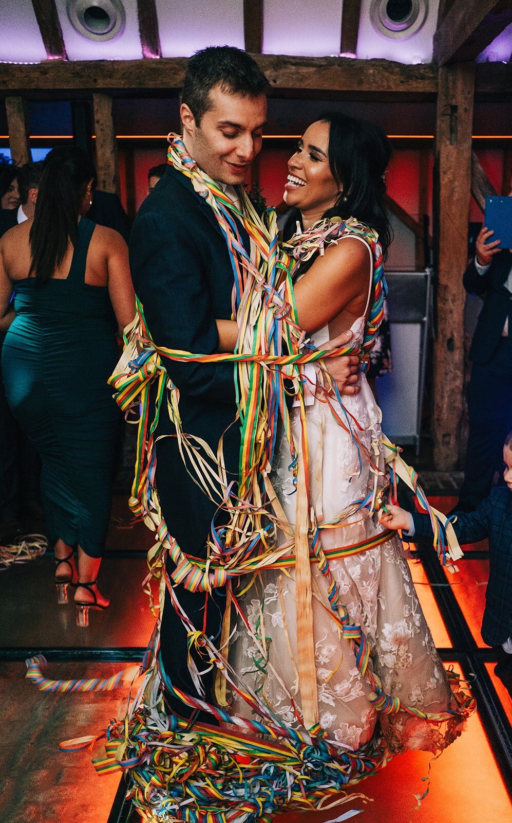 Bride and Groom on the dance floor in the Horse Barn taking part in rope tying tradition at rustic barn wedding venue in Hertfordshire