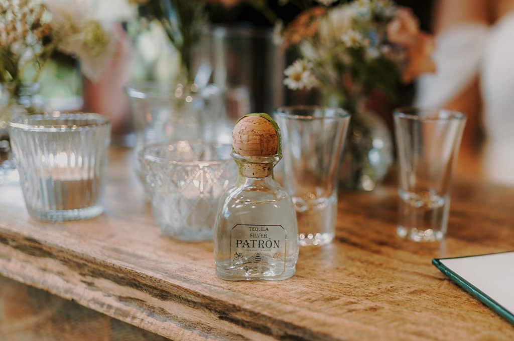 Tiny bottles of alcohol ready to be taken as a shot during humanist ceremony at barn wedding venue