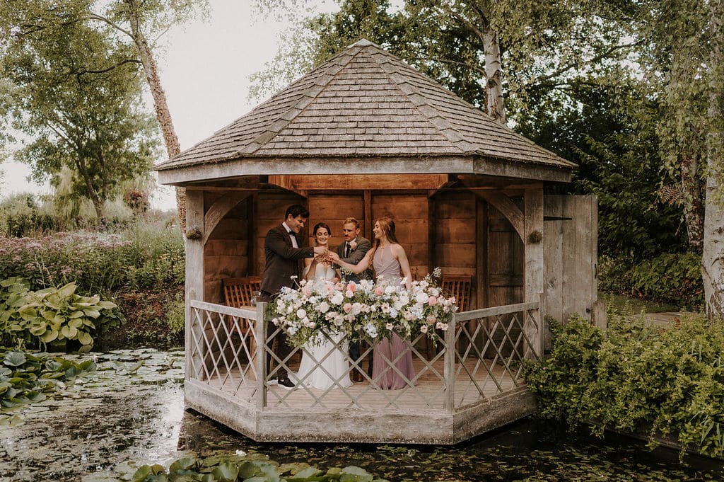 Bride an Groom with bridal party having a shot after the 'I do's in the stunning Summerhouse