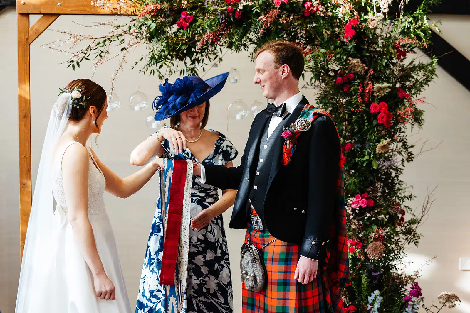 Bride and Groom in the Old Dairy hand fasting during their ceremony