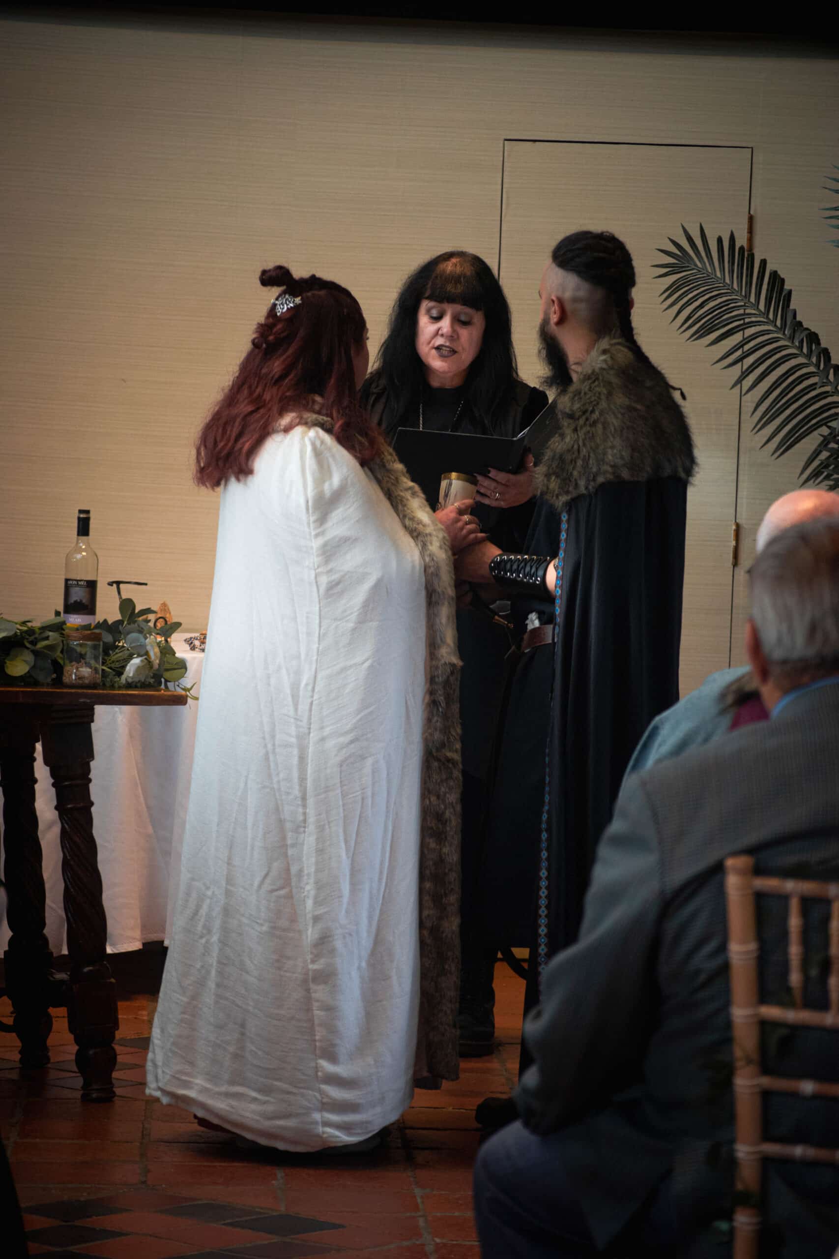 Bride and Groom dressed in traditional viking wear in the Old Dairy during their ceremony at intimate wedding venue in Hertfordshire