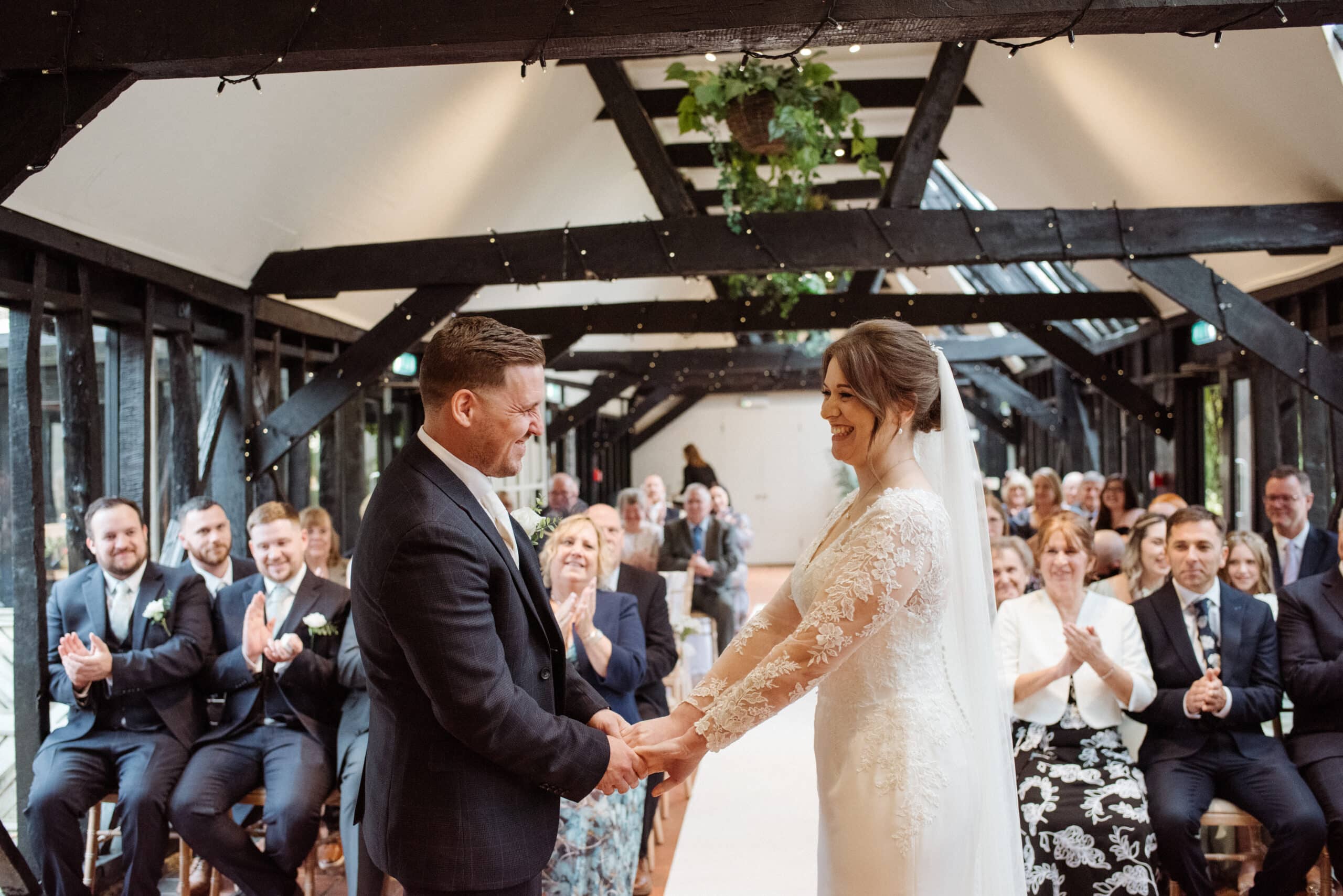 Bride and Groom standing in the Old Dairy saying their vowels during their intimate ceremony