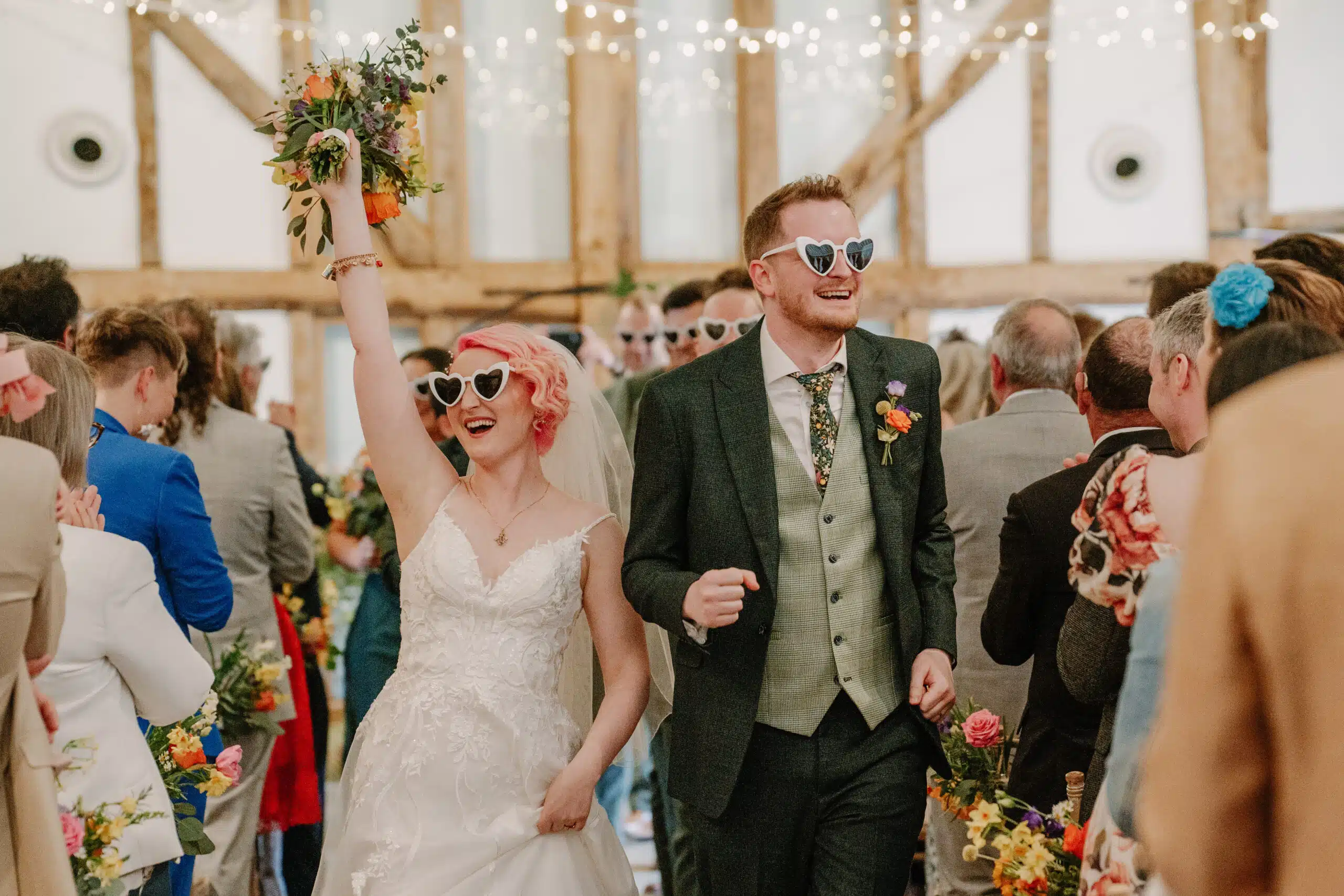 Bride with hands in air after the 'I do's' at countryside wedding venue in Bedfordshire
