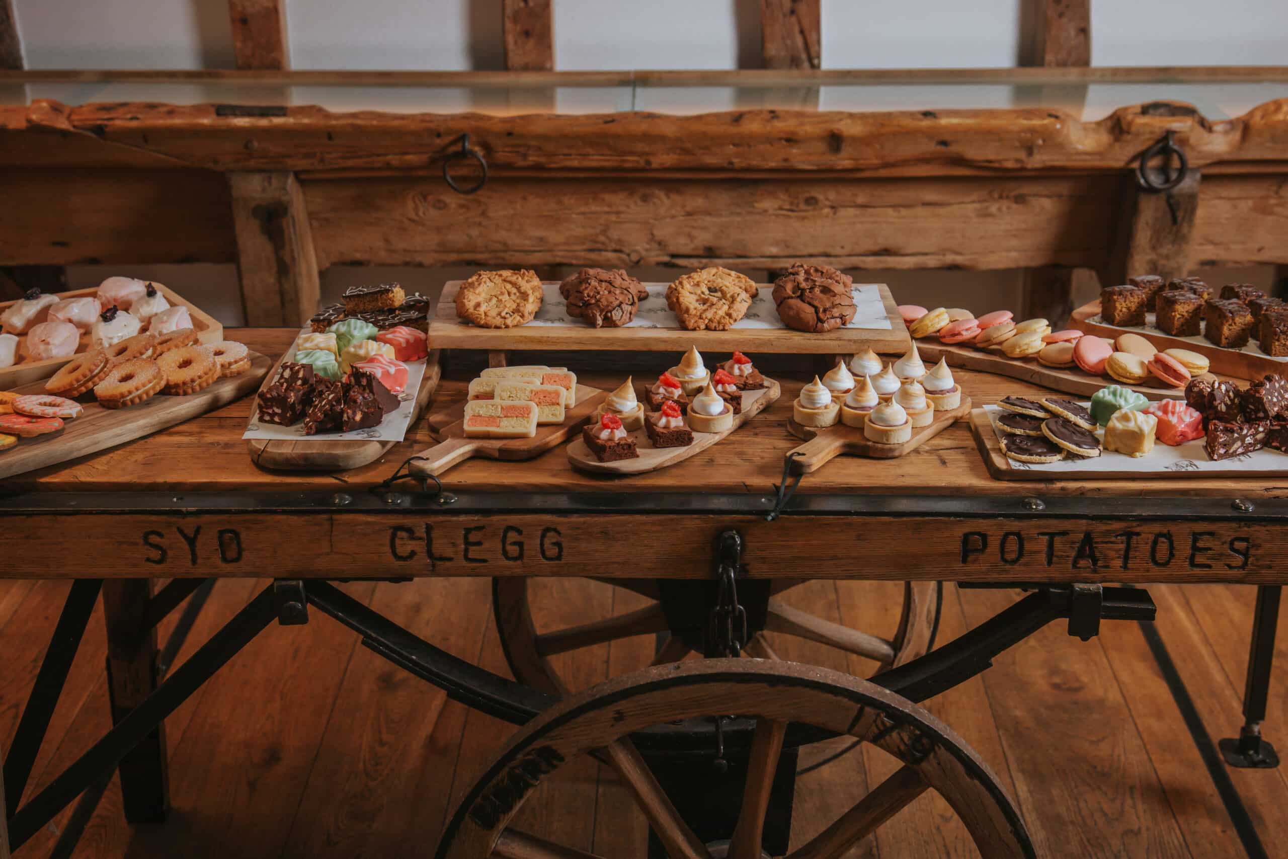 Wedding venue sweet treat cart display on vintage cart