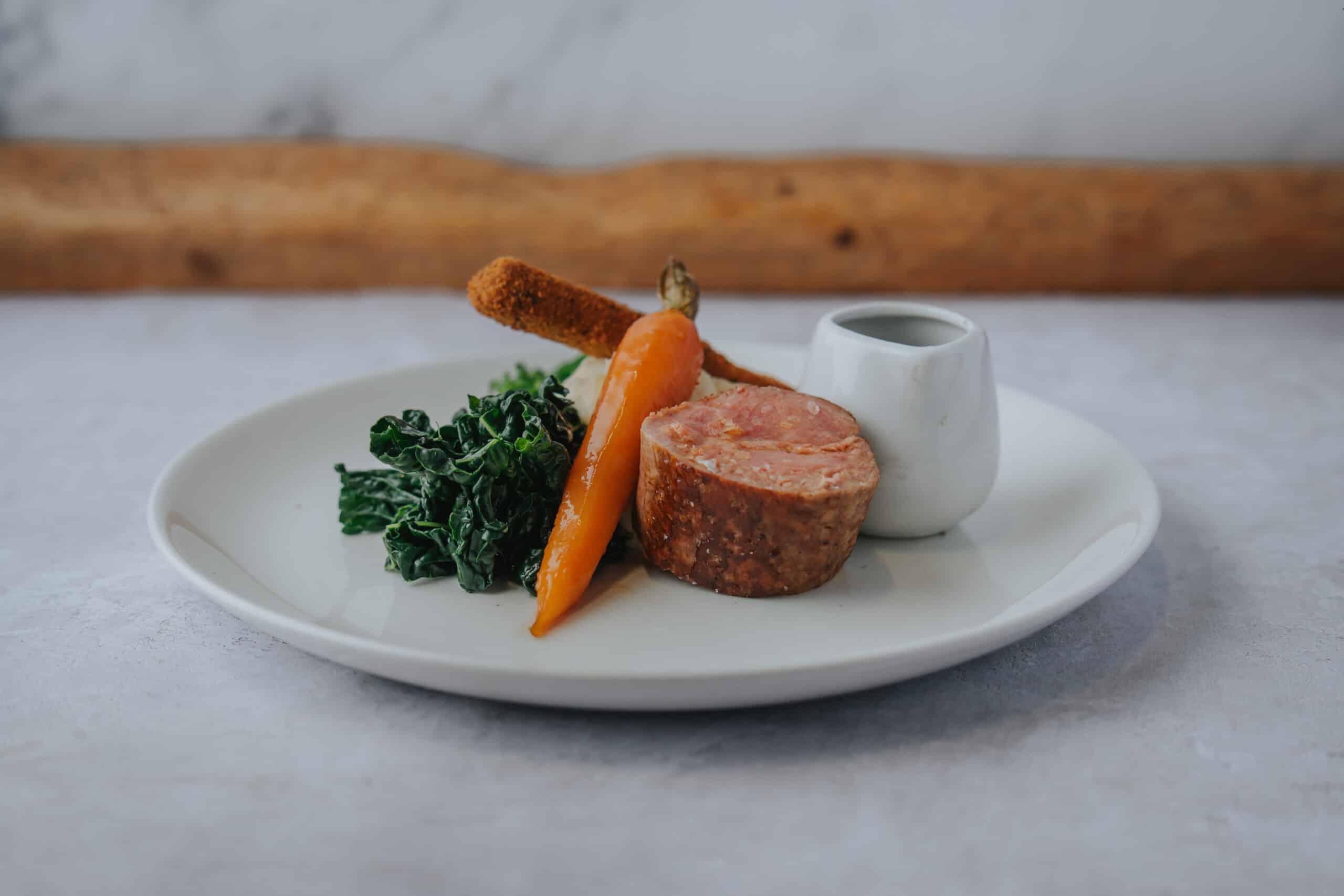 Wedding venue main course Stuffed & rolled Saddle of Lamb, Herb crusted Scrumpet, Red Wine & Rosemary Jus
