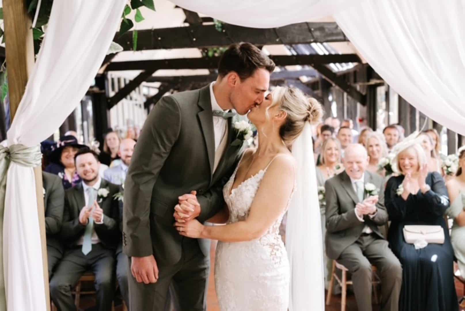 Bride and Groom sharing a kiss in The Old Dairy at countryside barn wedding venue in Hertfordshire