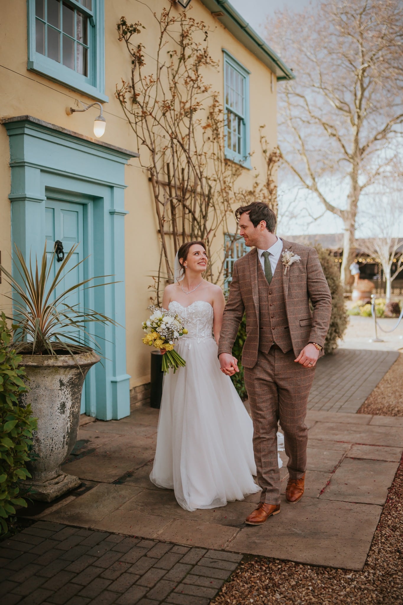 Couple walking outside a barn venue.