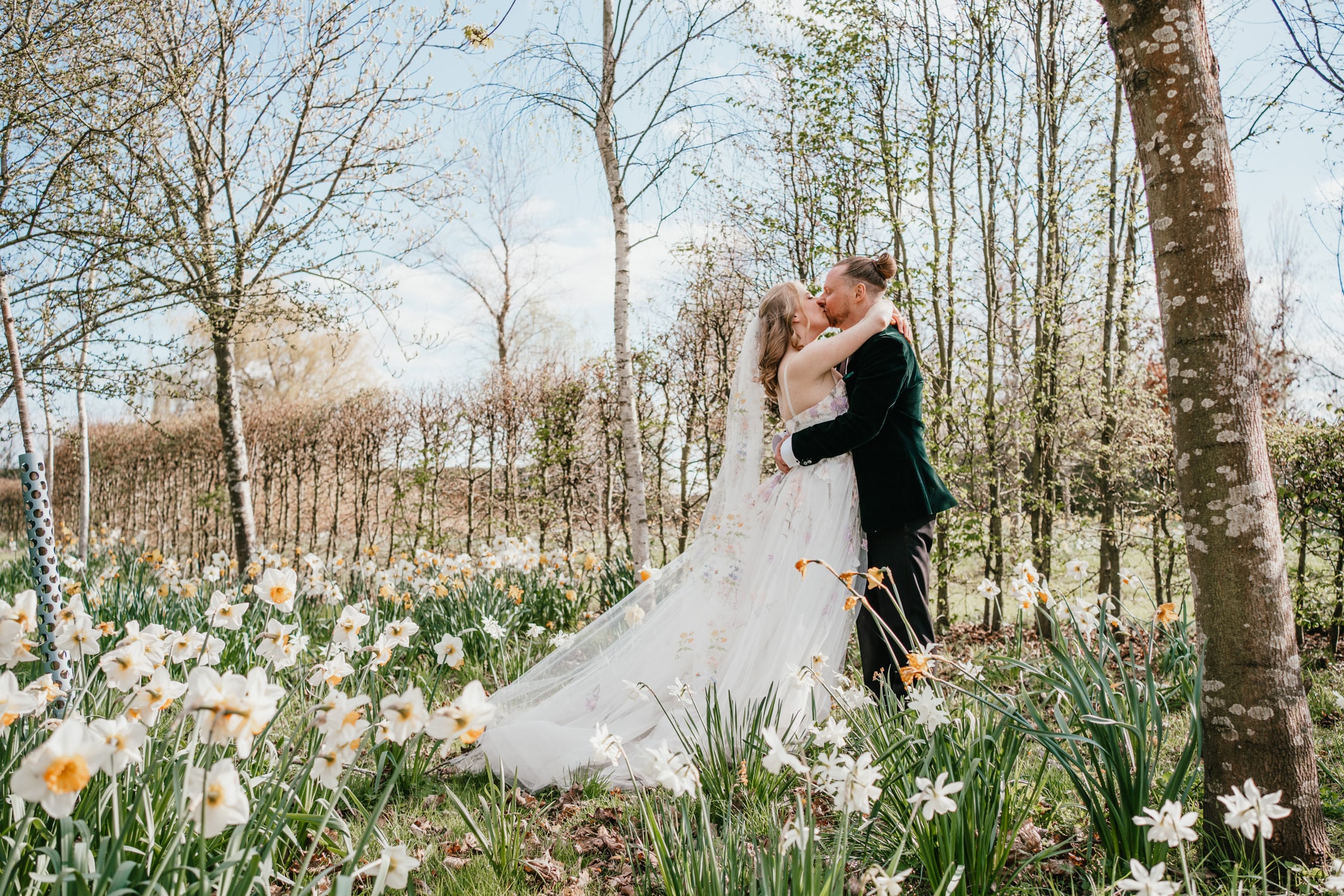Couple embracing in a flower garden.