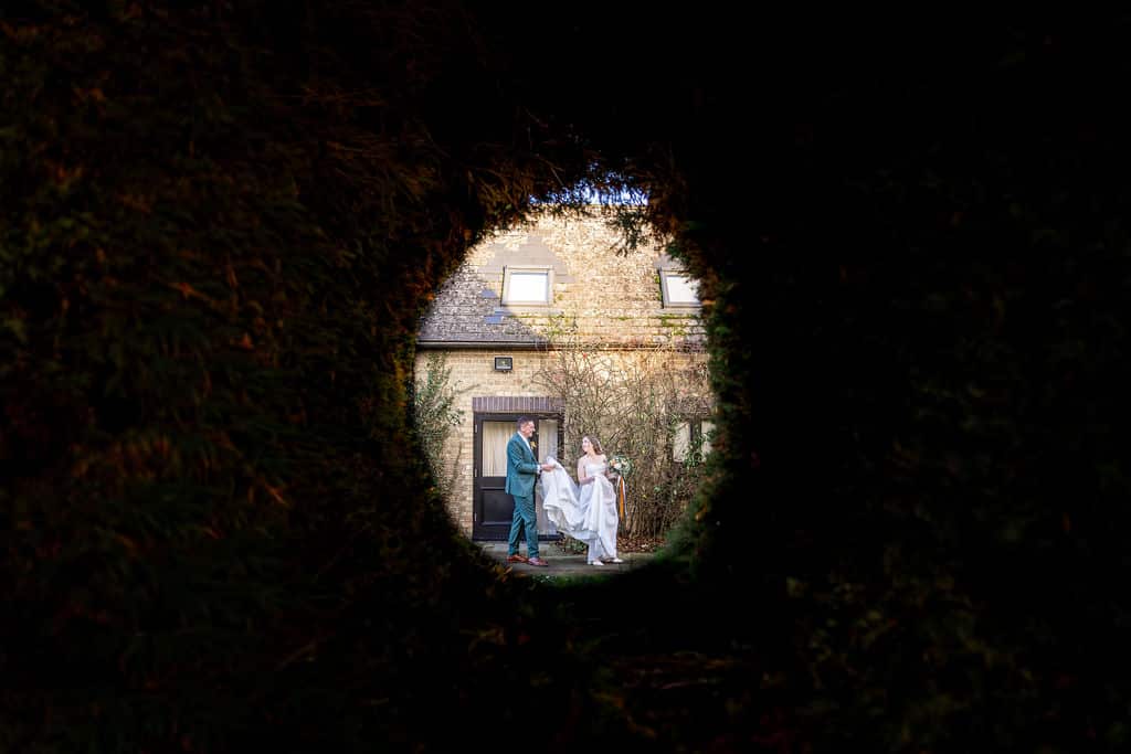 Couple walking through a circular opening.