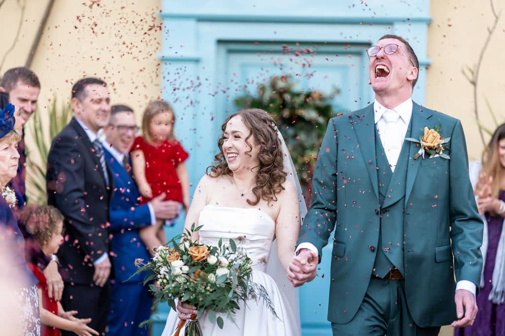 Joyful couple celebrating wedding outdoors