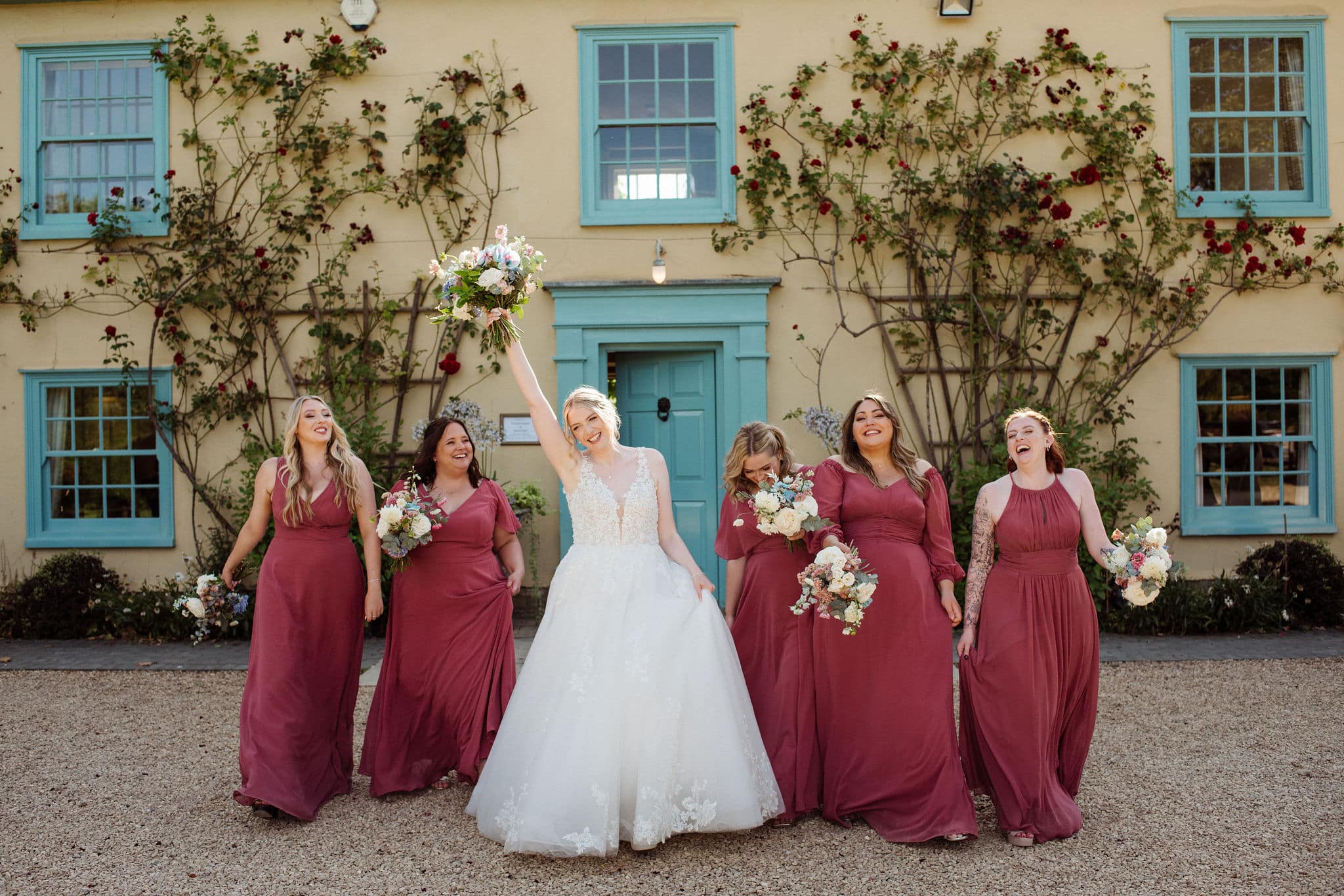 Bride and Bridesmaids outside countryside wedding venue on wedding day