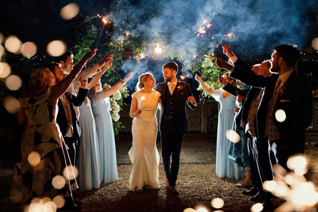 Intimate sparkler tunnel with bride, groom and their special guests