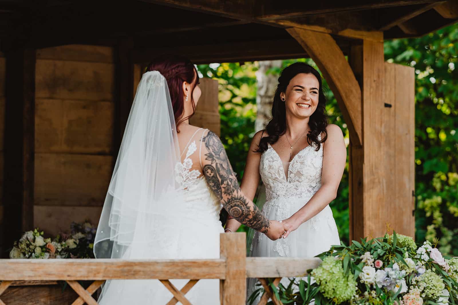 Bride and Bride in the Summerhouse during intimate outdoor ceremony at barn wedding venue in Hertforshire
