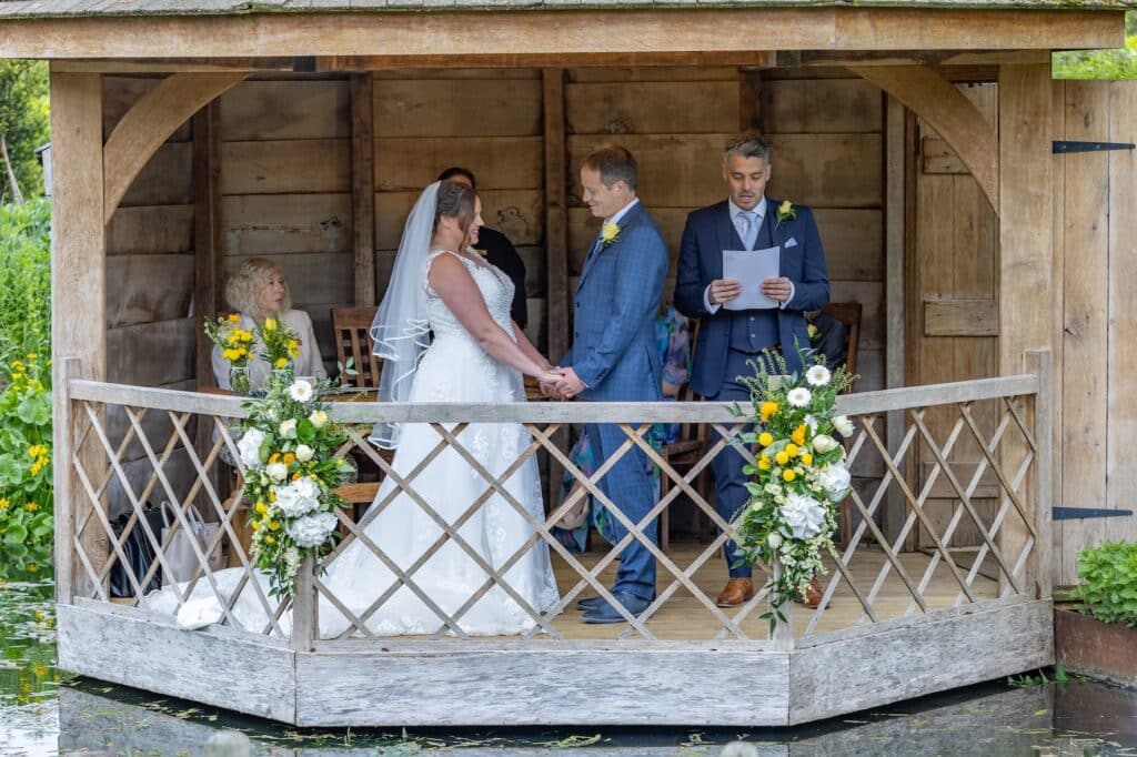 Bride and Groom on Wedding Day in pretty garden summer house