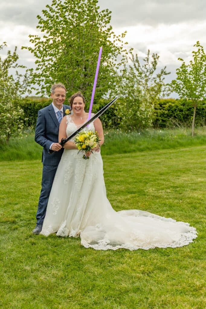 Bride and groom in stunning grass meadows on starwars themed wedding day